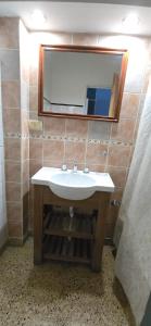 a bathroom with a sink and a mirror at Hotel Oviedo in Río Gallegos