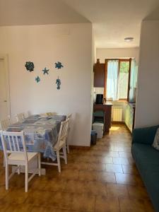 a dining room with a table and chairs at Villa Marina primo piano in Rio Marina +28 photos