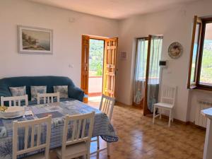 a living room with a table and a blue couch at Villa Marina primo piano in Rio Marina