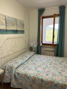 a bedroom with a bed and a window at Villa Marina primo piano in Rio Marina