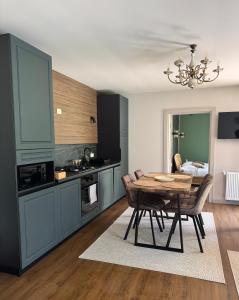 a kitchen with a table and a dining room at Cabana Forest in Borşa