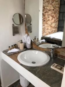 a bathroom counter with a sink and a mirror at Casa Moseua Hotel Boutique de Autor in Querétaro +65 photos