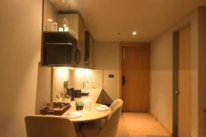 a dining room with a table and chairs and a television at The Signature Suite in Raipur