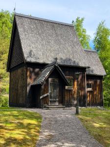 a large wooden building with a large door at Premium Stuga, Near Göta Canal & Tiveden National Park in Undenäs