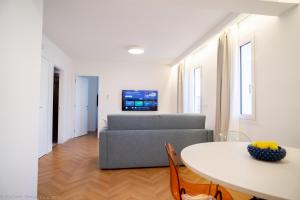 a living room with a couch and a table at Appartamento Bianca in Letojanni