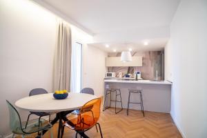 a small kitchen and dining room with a table and chairs at Appartamento Bianca in Letojanni +6 photos