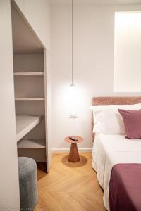 a bedroom with a bed and a book shelf at Appartamento Bianca in Letojanni