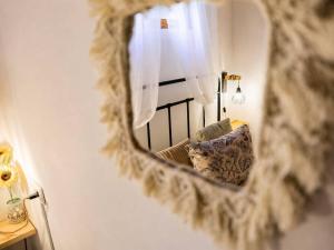 a mirror with a reflection of a chair in a room at Cazorla Centro|Cómodo apartamento de 2 dormitorios in Cazorla +7 photos
