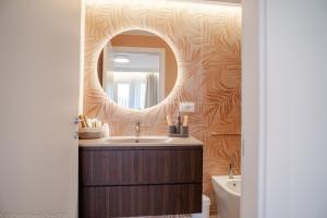 a bathroom with a sink and a mirror at Appartamento Bianca in Letojanni
