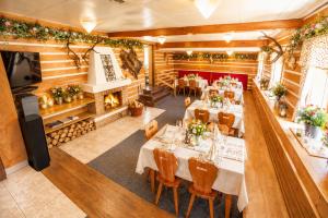 an overhead view of a restaurant with tables and a fireplace at Horská chata Hubert in Bedřichov