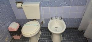 a bathroom with a toilet and a bidet at Hotel Oviedo in Río Gallegos +17 photos