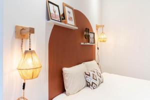 a bedroom with a bed and two lights and two shelves at Le West - Dinant Centre in Dinant +17 photos