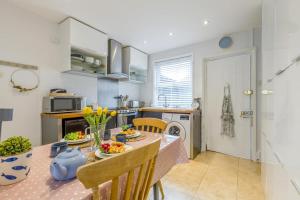 a kitchen with a table and a dining room at 2 Bed in Holt oc-2231 in Holt +12 photos