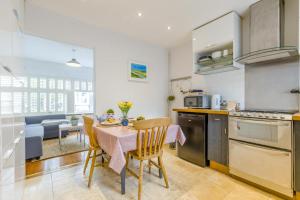 a kitchen and dining room with a table and chairs at 2 Bed in Holt oc-2231 in Holt