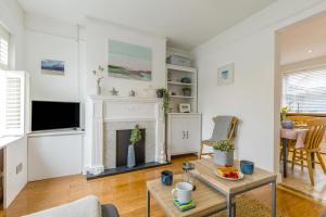 a living room with a fireplace and a table at 2 Bed in Holt oc-2231 in Holt