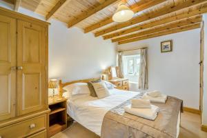 a bedroom with a large bed and a wooden ceiling at 3 Bed in Askrigg oc-ds926 in Askrigg
