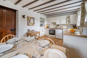 a kitchen with a table with wine glasses on it at 3 Bed in Askrigg oc-ds926 in Askrigg