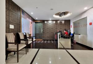 a man sitting at a desk in a lobby at Super Hotel O Rudra Grand in Hyderabad