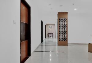 a hallway of a building with a chair in the distance at Super Hotel O Rudra Grand in Hyderabad