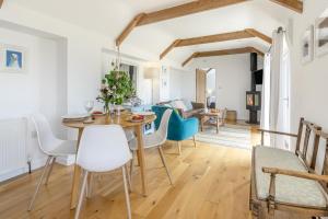 a dining room and living room with a table and chairs at 1 Bed in Penzance oc-78517 in Newlyn +20 photos