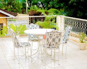 a white table and chairs on a patio at Furavia Hotel stay in Moshi