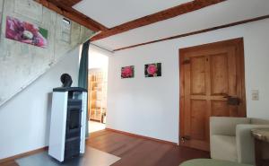 a living room with a fireplace and a door at Vacation apartment Stüble in Aichstetten