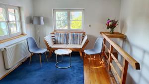 a living room with a couch and two chairs at Vacation apartment Stüble in Aichstetten