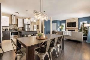 a kitchen and dining room with a table and chairs at Le Haut-Perche - Spa and River View in Petite-Rivière-Saint-François +19 photos