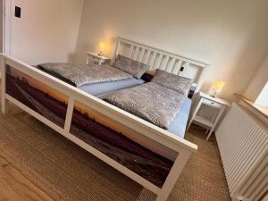 a large bed in a bedroom with two pillows at Ferienhaus Anna in Winsen