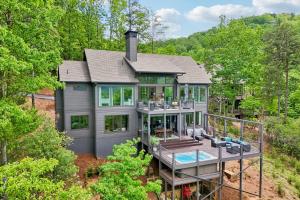 an aerial view of a house with a wrap around deck at Casa del Sueño - Big Canoe, GA - Take a Dip in the Private Swim Spa, Rack Up a Game of Pool, and Stay Active in the In-Home Fitn in Afton