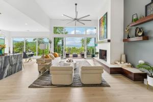 a living room with a couch and a fireplace at Casa del Sueño - Big Canoe, GA - Take a Dip in the Private Swim Spa, Rack Up a Game of Pool, and Stay Active in the In-Home Fitn in Afton +57 photos