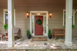 a front door of a house with a red door at K-Tees Cottage - Big Canoe,GA - Soak in the Private Hot Tub, Challenge Friends in the Arcade, Take in Scenic Golf Course Views, in Holcomb