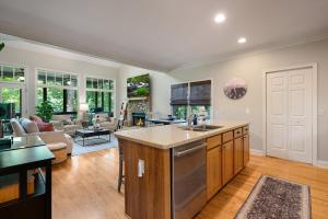 an open kitchen and living room with a couch at K-Tees Cottage - Big Canoe,GA - Soak in the Private Hot Tub, Challenge Friends in the Arcade, Take in Scenic Golf Course Views, in Holcomb +58 photos