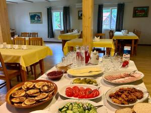a table with many plates of food on it at Rõuge Suurjärve Külalistemaja in Rõuge +20 photos