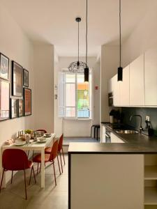 a kitchen and dining room with a table and chairs at Veniero37 Guest House in Rome