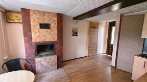 a living room with a fireplace and a table at Przytulne studio 