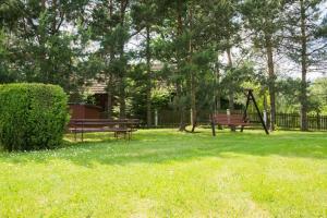 a park with two benches and a swing at Przytulne studio 