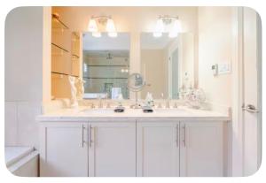 a bathroom with a sink and a large mirror at Unique Home - Upper Toronto Beaches in Toronto +35 photos