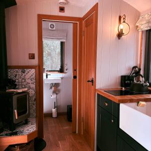 a small kitchen with a sink and a microwave at Oakwood Marina in Northwich +13 photos