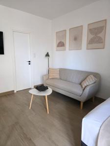 a living room with a couch and a table at Kalamea Apartment Kalathas in Kalathas