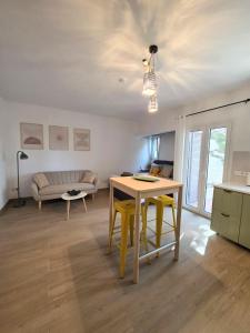 a living room with a table and a couch at Kalamea Apartment Kalathas in Kalathas +14 photos