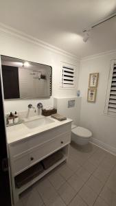 a white bathroom with a sink and a toilet at 22 Emoyeni Drive in Hillcrest
