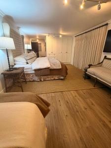 a hotel room with two beds and a couch at 22 Emoyeni Drive in Hillcrest