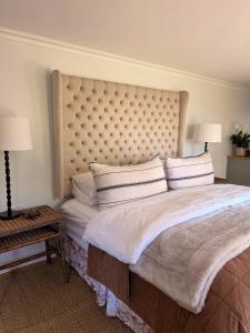 a bedroom with a large bed with a large headboard at 22 Emoyeni Drive in Hillcrest