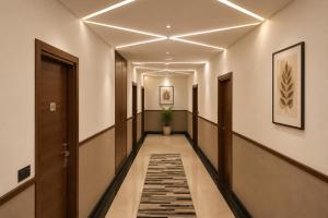 a corridor of a hallway with a long hallway at Hotel Kartikey Near Jio Centre in Sundarnagar