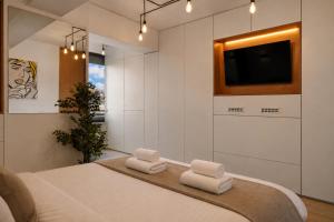 a bedroom with a bed with two white towels at RHUM B03 - Dome View in Bucharest