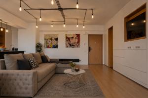 a living room with a couch and a table at RHUM B03 - Dome View in Bucharest