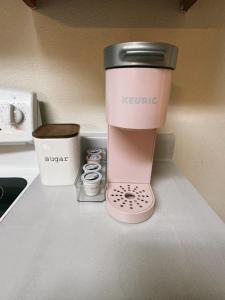 a pink mixer sitting on a counter next to a cup at My apartment in Georgetown 2 Bedroom in Georgetown