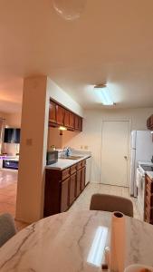 a kitchen with a table and a kitchen with a refrigerator at My apartment in Georgetown 2 Bedroom in Georgetown