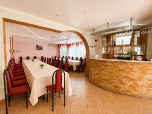 a restaurant with a table and chairs and a bar at Готель Українське in Vinnytsya